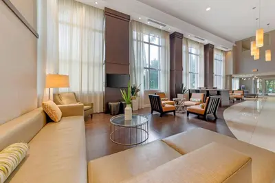 a large living room with a couch and chairs at Comfort Suites Miami Airport North in Miami
