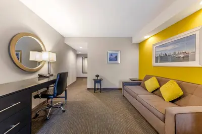 a living room with a couch and a desk at Comfort Suites Miami Airport North in Miami