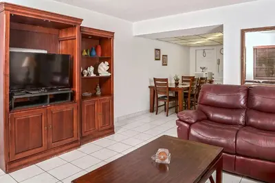 a living room with a couch and a television at Shell Motel Hollywood in Hollywood