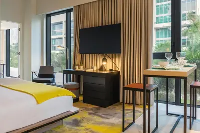 a bedroom with a bed and a desk with a tv at Hyde Suites Midtown Miami in Miami