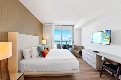 a bedroom with a bed with a desk and a window at Lyfe Residence Building - Private apts over the beach in Hollywood