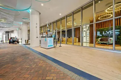 an empty lobby of a shopping mall with people walking around at Lyfe Residence Building - Private apts over the beach in Hollywood