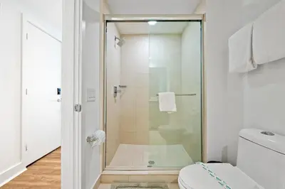 a bathroom with a glass shower with a toilet at Lyfe Residence Building - Private apts over the beach in Hollywood