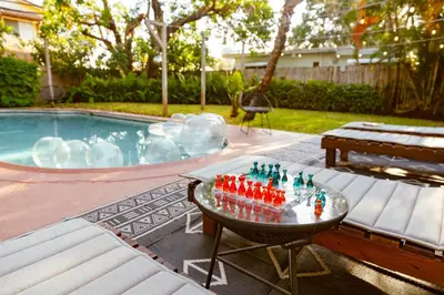 a pool with a chess board on a table in front of it at Casa del Ojo- Heated Pool - 3 King beds in Fort Lauderdale
