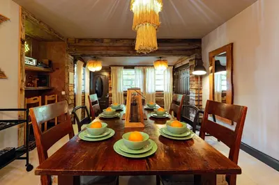 a dining room with a wooden table and chairs at Casa del Ojo- Heated Pool - 3 King beds in Fort Lauderdale