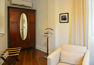 a living room with a chair and a mirror at Hotel St. Michel in Miami
