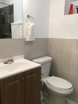 a bathroom with a white toilet and a sink at Close to Everything Miami in Miami