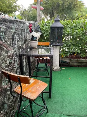 a table and a chair and a table with a lamp at Habitación Céntrica calle 8 Miami in Miami