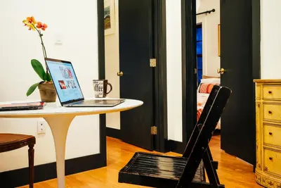 a laptop computer sitting on a table in a room at Renovated Historic Coconut Grove Cottage Home in Miami