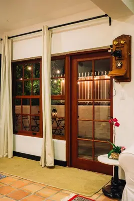 a room with a door and two windows at Renovated Historic Coconut Grove Cottage Home in Miami