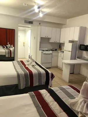 a hotel room with two beds and a kitchen at Casablanca on the beach, Oceanfront Studio Miami Beach in Miami Beach