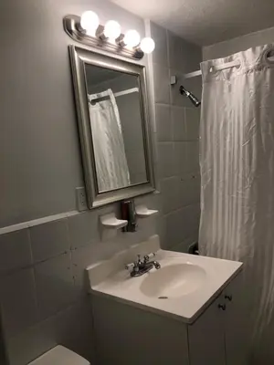 a bathroom with a sink and a mirror and a toilet at Casablanca on the beach, Oceanfront Studio Miami Beach in Miami Beach