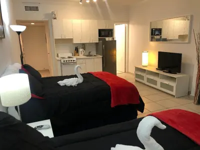 a living room with a couch and a swan blanket at Casablanca on the beach, Oceanfront Studio Miami Beach in Miami Beach