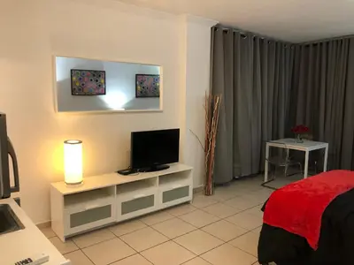 a bedroom with a bed and a flat screen tv at Casablanca on the beach, Oceanfront Studio Miami Beach in Miami Beach