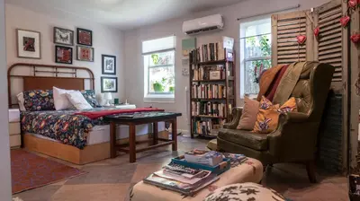 a living room with a bed and a chair at The Wild Rose in Miami