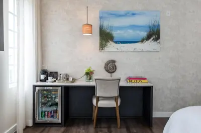 a desk with a chair and a picture of the beach at The Marlin Hotel in Miami Beach