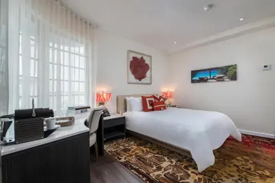 a bedroom with a bed and a desk with a computer at The Marlin Hotel in Miami Beach
