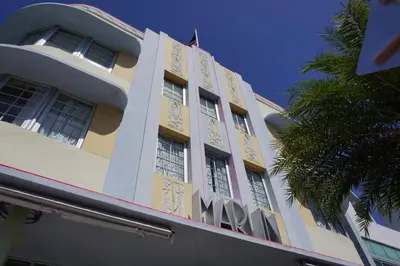 a building with a palm tree in front of it at The Marlin Hotel in Miami Beach