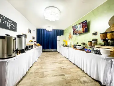 a restaurant with white tables and a counter with food at Paradise Oceanfront by HBH in Hollywood