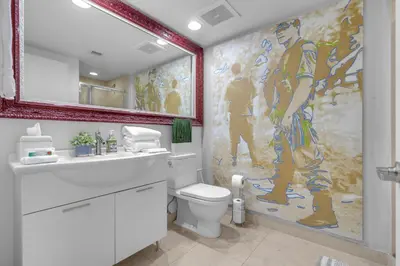 a bathroom with a toilet and a large painting on the wall at Luxury Waterfront Condo In The Urban Oasis At Icon-Brickell Free Spa in Miami