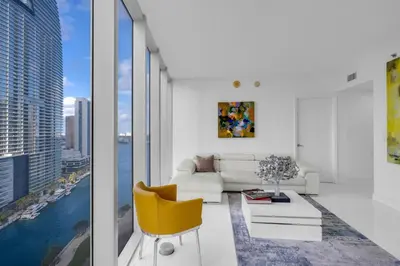 a living room with a couch and a yellow chair at Luxury Waterfront Condo In The Urban Oasis At Icon-Brickell Free Spa in Miami