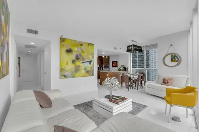 a white living room with a white couch and a yellow chair at Luxury Waterfront Condo In The Urban Oasis At Icon-Brickell Free Spa in Miami