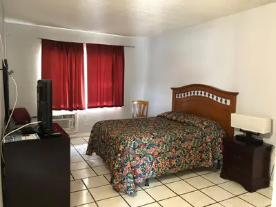 a bedroom with a bed and a television in it at Ramona Motel in Miami