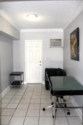 a living room with a ping pong table in it at Ramona Motel in Miami