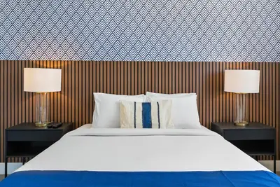 a bedroom with a bed and two lamps on tables at MILLA South Beach in Miami Beach