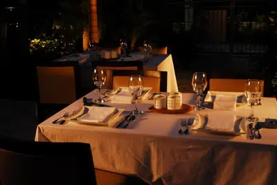 a table with wine glasses and napkins on it at Provident Doral At The Blue in Miami