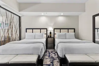 two beds in a room with white walls at Provident Doral At The Blue in Miami