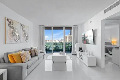 a white living room with a couch and a table at Great Apartment with beach access in Hollywood