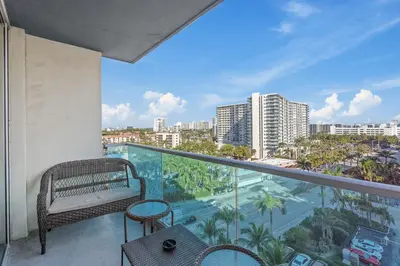 a balcony with a bench and a view of a city at Great Apartment with beach access in Hollywood