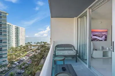 a balcony with a bench and a view of the ocean at Great Apartment with beach access in Hollywood