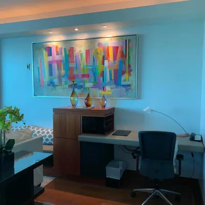 an office with a desk and a painting on the wall at One Bal Harbour Ritz Bal Harbour in Miami Beach