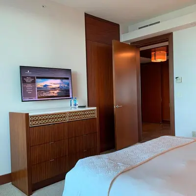 a bedroom with a bed and a flat screen tv at One Bal Harbour Ritz Bal Harbour in Miami Beach