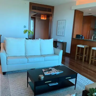 a living room with a blue couch and a coffee table at One Bal Harbour Ritz Bal Harbour in Miami Beach