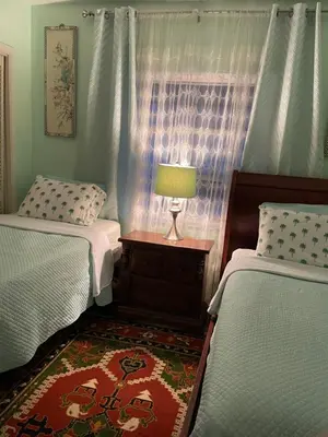 a bedroom with two beds and a lamp on a table at House next to the golf course in Plantation
