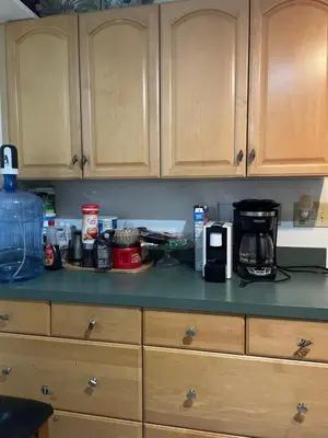 a kitchen counter topped with a coffee maker and a coffee pot at House next to the golf course in Plantation