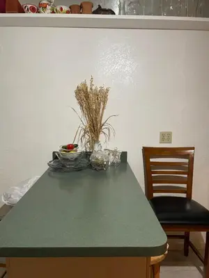 a table with a green counter top and two chairs at House next to the golf course in Plantation