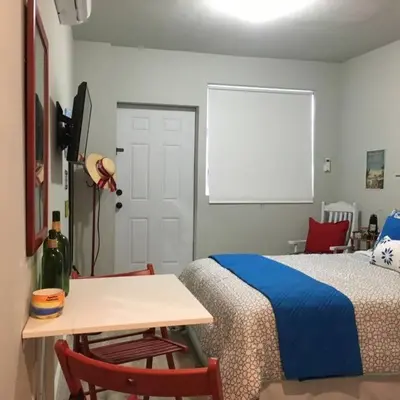 a bedroom with a bed and a table and a window at Walk to Restaurants and Shops - 5S in Miami