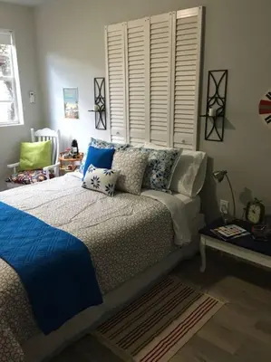 a bedroom with a bed with blue and white pillows at Walk to Restaurants and Shops - 5S in Miami