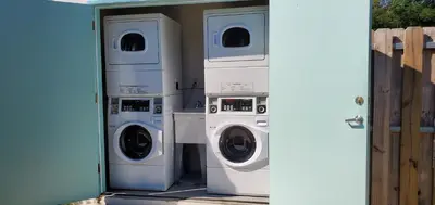 two washing machines and a washer and dryer in a garage at Cottages El Portal in Miami