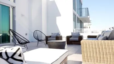 a patio with chairs and tables on a building at 6080 Design Hotel by Eskape Collection in Miami Beach