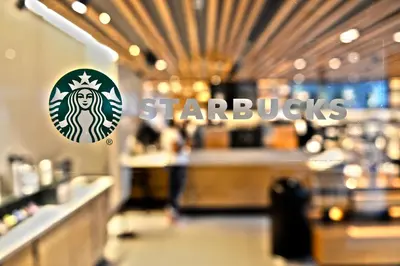 a starbucks restaurant with a starbucks sign in the foreground at 6080 Design Hotel by Eskape Collection in Miami Beach