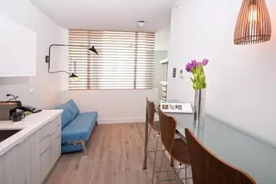 a kitchen with a table and a blue couch at 6080 Design Hotel by Eskape Collection in Miami Beach