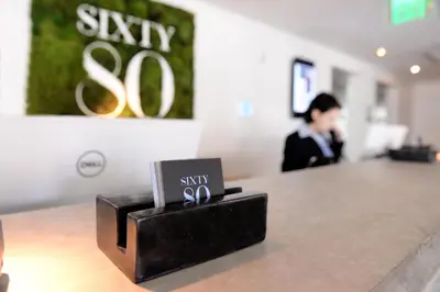 a sign that says sixty sixty sitting on top of a counter at 6080 Design Hotel by Eskape Collection in Miami Beach