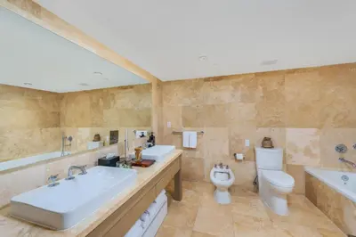 a bathroom with two sinks and a toilet and a tub at Oceanview Private Condo at 1 Hotel & Homes -1544 in Miami Beach