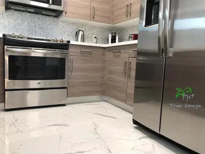 a kitchen with stainless steel appliances and marble floors at Yacht Club at Aventura 2 Bed 2 bath Luxurius Cozy Brand New in Aventura