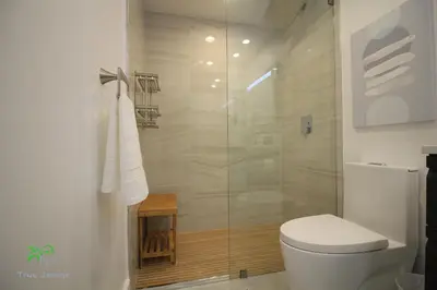 a bathroom with a toilet and a glass shower at Yacht Club at Aventura 2 Bed 2 bath Luxurius Cozy Brand New in Aventura